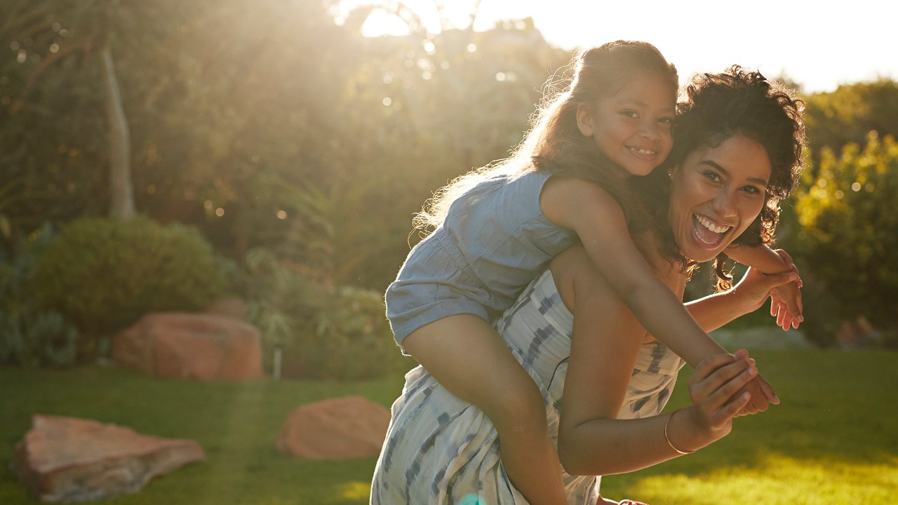 mother laughing and carrying daughter; image used for hsbc Sri Lanka insurance page