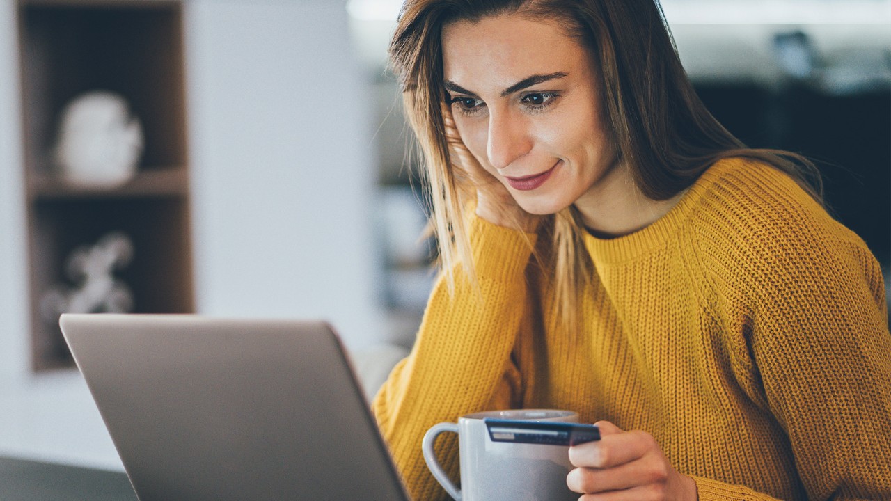 A woman looking at her laptop smiling; image used for HSBC Sri Lanka Card Instalment Plan page