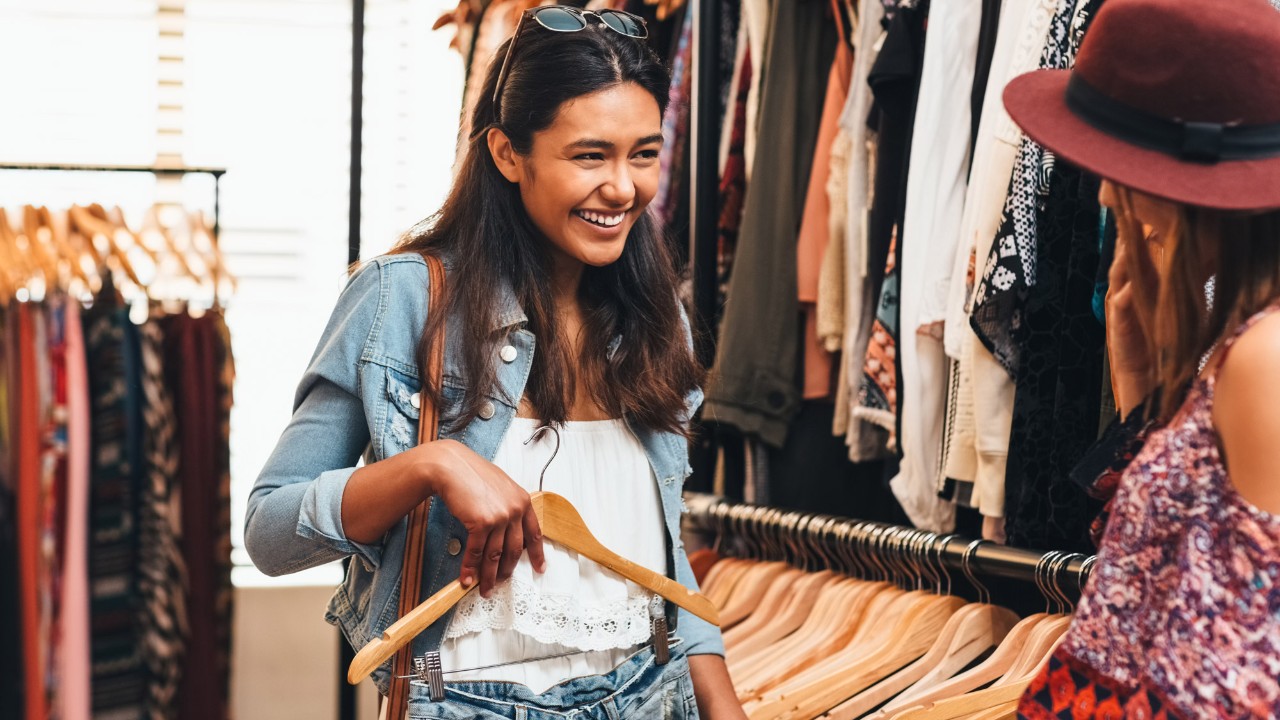 two young women picking up clothes together; image used for HSBC Sri Lanka Credit Cards Rewards