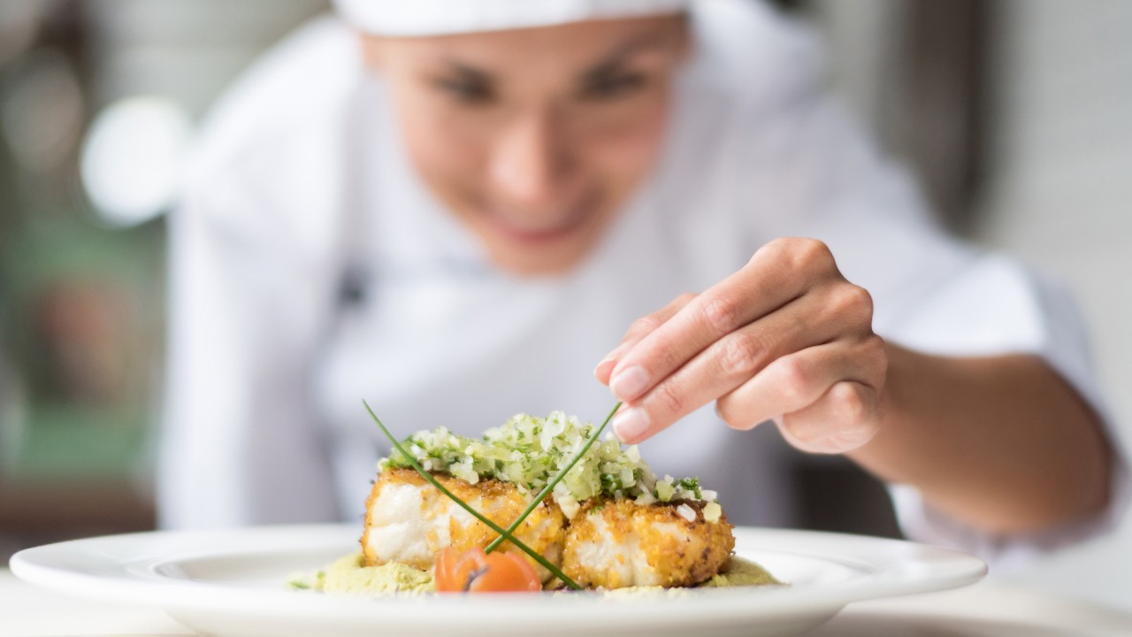 A female chief dressing up a delicate dish; image used for HSBC Sri Lanka credit card wine and dine offer page